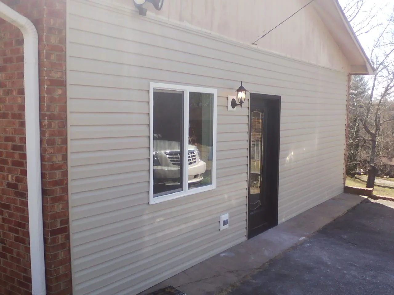 New vinyl siding and entry door on a room addition in Boswell