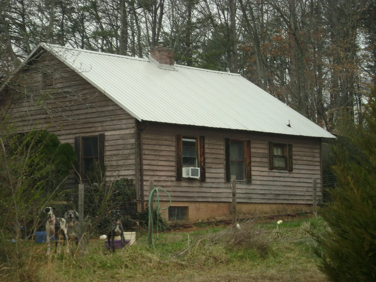 White metal roof on an old wood sided farmhouse, from a Metal Roof Installation job in Boswell